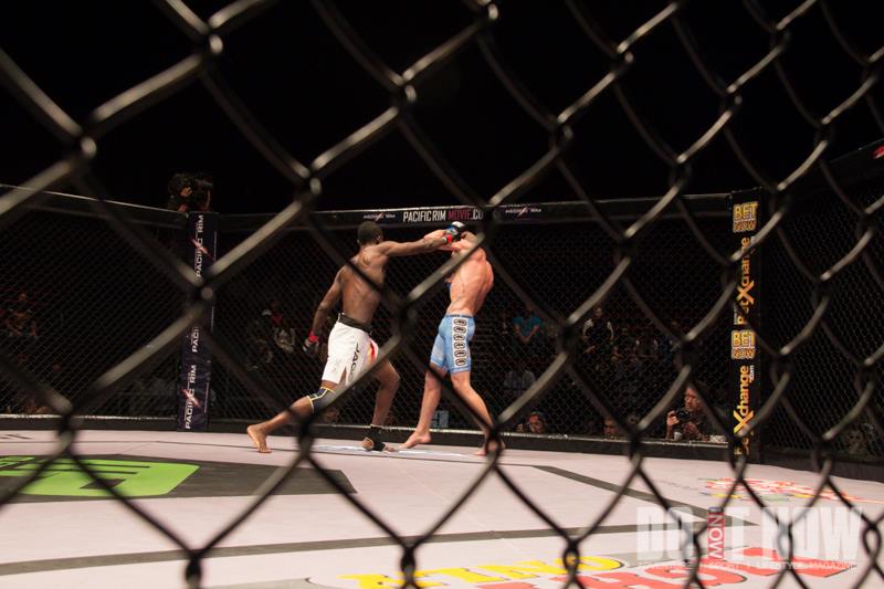 Two fighters exchanging strikes inside the cage